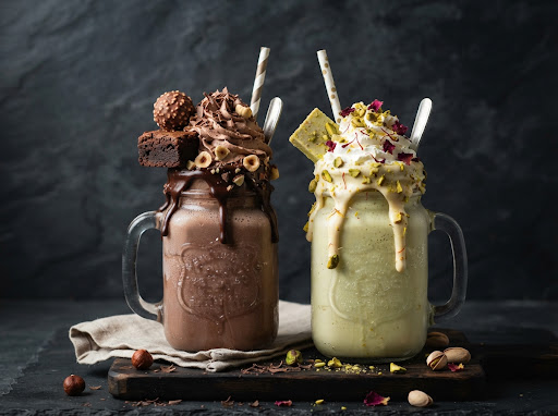Decadent artisanal thick milkshakes in chilled mason jars, nutella hazelnut brownie shake dripping chocolate
